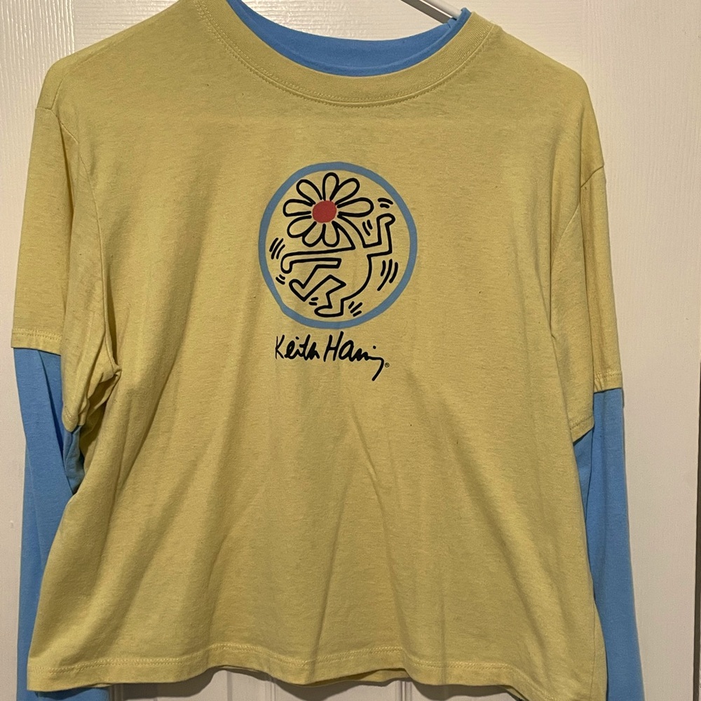 A long sleeve tee from Keith Haring with his iconic flower head art💛💙